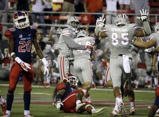 UNLV Rebels' Troy Hawthorne (11) hugs UNLV Rebels placekicker Nicolai Bornand (40) after Bornand kicked a game winning field goal in overtime of an NCAA college football game against the Fresno State Bulldogs Friday, Oct. 10, 2014, in Las Vegas. The Rebels won 30-27.