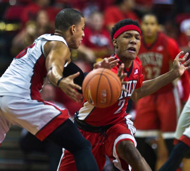 UNLV's Kendall Smith, left, and Patrick McCaw fight for the ball during the Scarlet and Gray exhibition game Thursday, Oct. 16, 2014, at the Thomas & Mack Center.