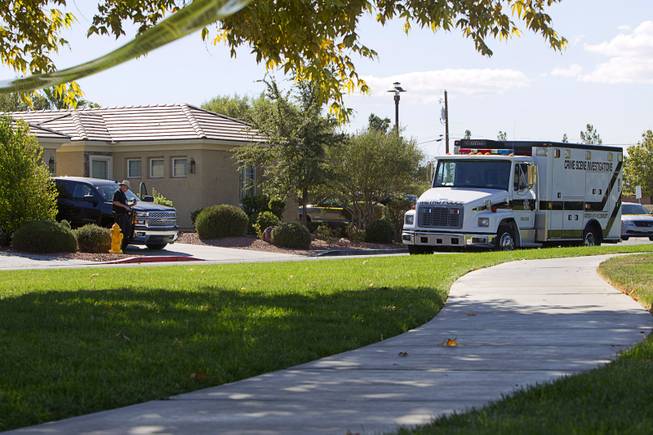 A Metro Police crime scene truck shown by a home in the 8500 block of Berkley Hall Street, near West Grand Teton Drive and North Buffalo Drive Monday, Oct. 20, 2014. A woman is dead and a man suffered substantial injuries after a domestic dispute at the house, police said.