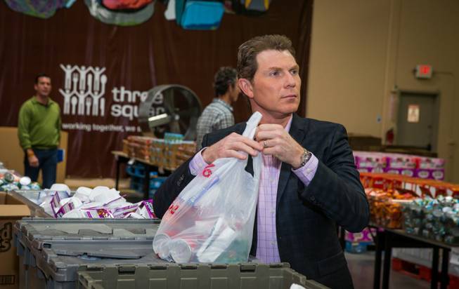 Celebrity chef Bobby Flay visits Three Square food bank Tuesday, Oct. 14, 2014, in Las Vegas.