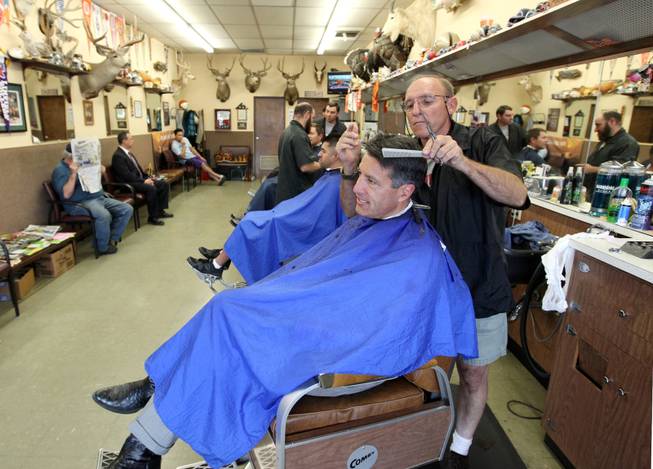 Barber Don Diehl cuts Gov. Brian Sandoval's hair, in Sparks, Nev., on Thursday, Oct. 14, 2014. Sandoval says going to the Paradise Park Barber Shop is a family tradition. .Photo by Cathleen Allison