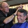 Barber Don Diehl cuts Gov. Brian Sandoval’s hair Thursday, Oct. 14, 2014, in Sparks. Diehl says they don't talk politics — it’s all about family and sports.
