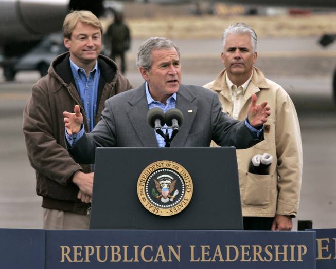 President Bush gestures while addressing a crowd at a campaign rally in Elko, Nev., Thursday, Nov. 2, 2006.  Bush stopped to campaign  for Nevada Secretary of State Dean Heller, left, who is seeking a seat a Congressional seat and Sen. John Ensign, right, who is  up for re-election.(AP Photo/Rich Pedroncelli)