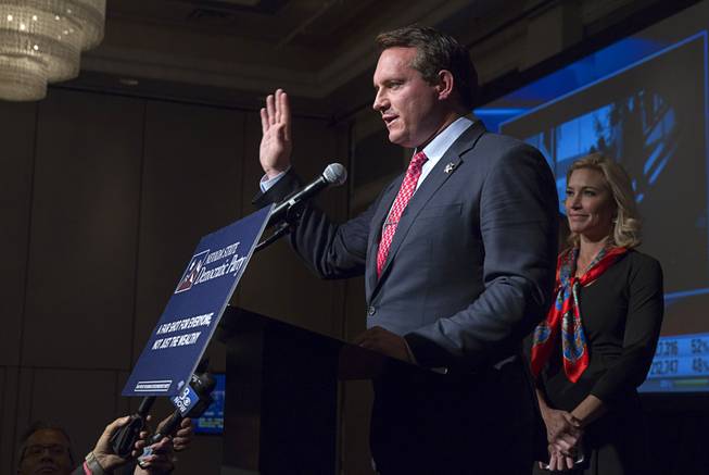 Ross Miller is joined by his wife, Lesley, as he delivers a concession speech during an election night party for Democrats at the MGM Grand on Tuesday, Nov. 4, 2014. Miller was running for Nevada attorney general. 