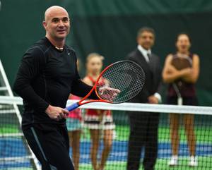 Andre Agassi plays doubles for fans on hand at the grand opening of Life Time Athletic on Thursday, Nov. 6, 2014, in Green Valley.