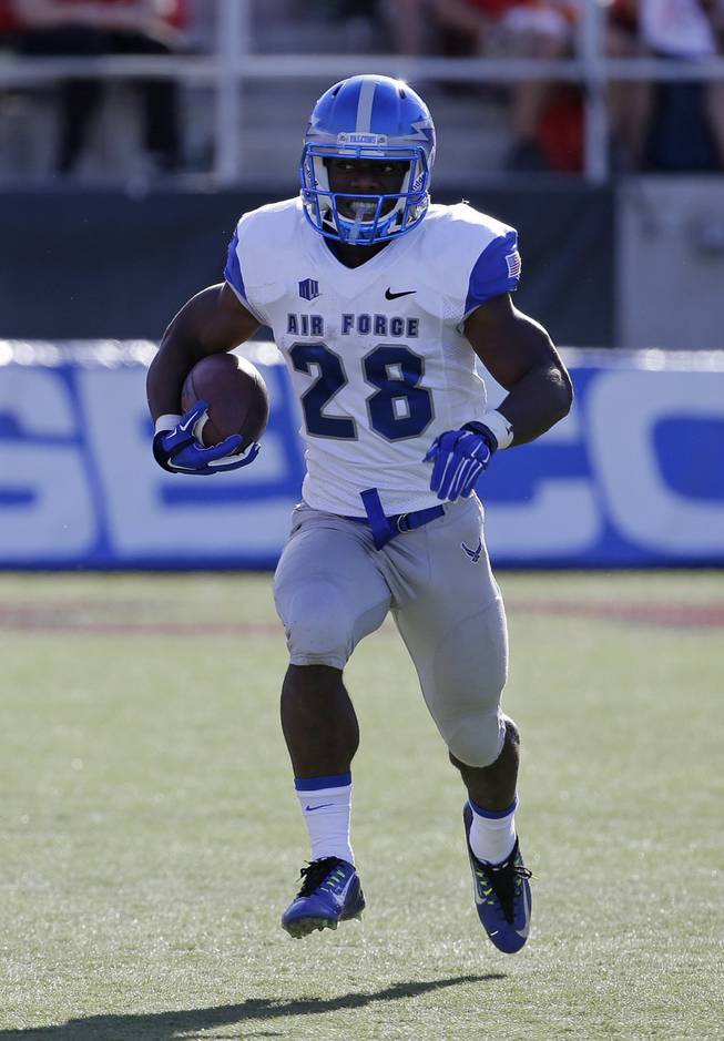 Air Force running back Jacobi Owens (28) runs with the ball during the first half of an NCAA college football game against UNLV Saturday, Nov. 8, 2014, in Las Vegas. Air Force won 48-21. (AP Photo/John Locher)