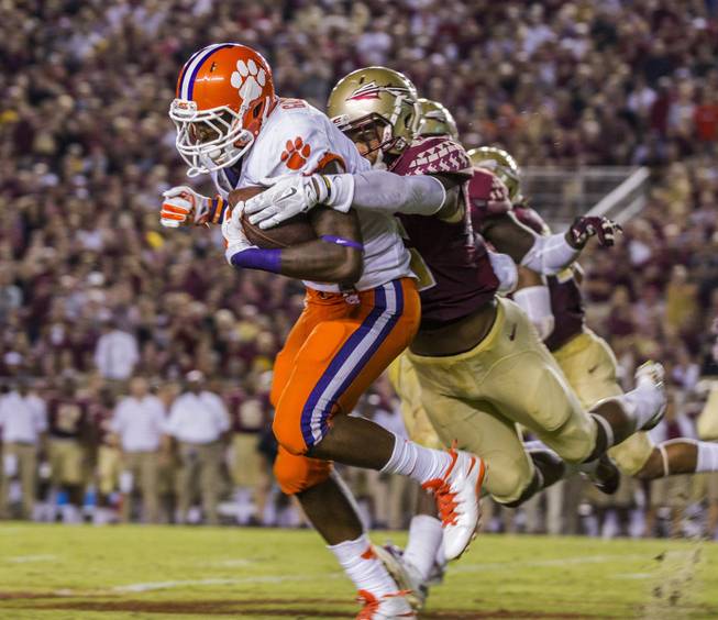Clemson's Wayne Gallman, left, gets dragged down by Florida State's P.J. Williams on a kick return in the first half of an NCAA college football game in Tallahassee, Fla., Saturday, Sept. 20, 2014. (AP Photo/Mark Wallheiser)
