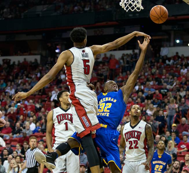 UNLV's Christian Wood slaps away a shot attempt by Morehead State's Brent Arrington during the Rebels' home opener on Friday, Nov. 14, 2014. 