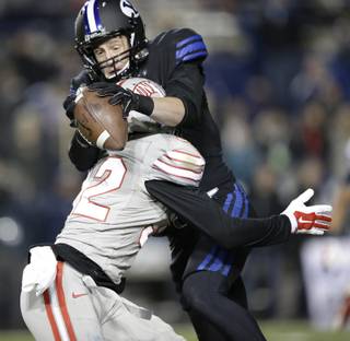Brigham Young wide receiver Mitch Mathews, rear, catches a pass over the back of UNLV defensive back Mike Horsey (32) in the second quarter during an NCAA college football game Saturday, Nov. 15, 2014, in Provo, Utah. (AP Photo/Rick Bowmer)