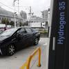 Toyota’s new fuel cell vehicle Mirai arrives at a charge station near Toyota's showroom Monday, Nov. 17, 2014, in Tokyo.