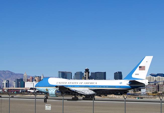 Strip casinos are shown in the background as Air Force One takes off at McCarran International Airport Sunday, Nov. 23, 2014.