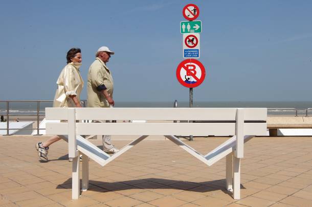 People walk past a bench designed for a project called 'Modified Social Benches' by Danish artist Jeppe Hein, during the Beaufort04 Triennial of Contemporary Art exhibition along the Belgian coast, in De Haan, Wednesday, June 20, 2012. 