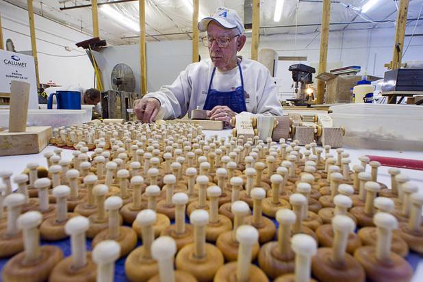 Elmer Griggs assembles wheels and axles on toy cars at the Toys 4 Smiles workshop Monday, Dec. 8, 2014. The nonprofit organization started as a wood club in 2006 and will soon produce their 200,000th toy, said founder Rex Doty.