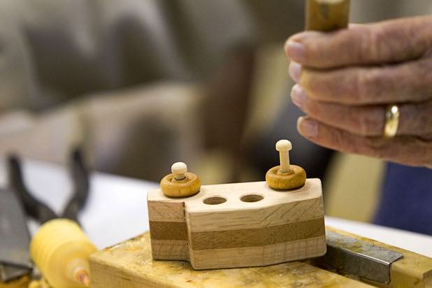 Elmer Griggs assembles wheels and axles on toy cars at the Toys 4 Smiles workshop Monday, Dec. 8, 2014. The nonprofit organization started as a wood club in 2006 and will soon produce their 200,000th toy, said founder Rex Doty.