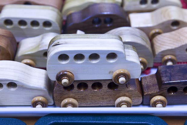 Toy cars dry after being dipped in mineral oil at the Toys 4 Smiles workshop Monday, Dec. 8, 2014. The nonprofit organization started as a wood club in 2006 and will soon produce their 200,000th toy, said founder Rex Doty.