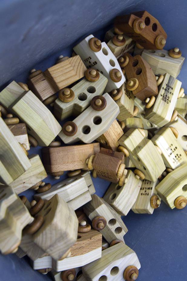 Finished cars are shown in a bin at the Toys 4 Smiles workshop Monday, Dec. 8, 2014. The nonprofit organization started as a wood club in 2006 and will soon produce their 200,000th toy, said founder Rex Doty.