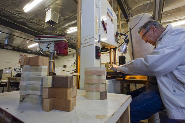 Bud Lampkin cuts out toy cars on a band saw at the Toys 4 Smiles workshop Monday, Dec. 8, 2014. The nonprofit organization started as a wood club in 2006 and will soon produce their 200,000th toy, said founder Rex Doty.