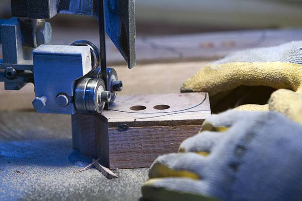 Bud Lampkin cuts out toy cars on a band saw at the Toys 4 Smiles workshop Monday, Dec. 8, 2014. The nonprofit organization started as a wood club in 2006 and will soon produce their 200,000th toy, said founder Rex Doty.