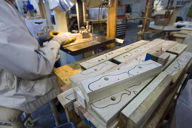 Bud Lampkin cuts out toy cars on a band saw at the Toys 4 Smiles workshop Monday, Dec. 8, 2014. The nonprofit organization started as a wood club in 2006 and will soon produce their 200,000th toy, said founder Rex Doty.