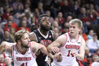 Jordan Cornish of UNLV gets squeezed between Eric Robertson (41) and Casey Kasperbauer (14) on Saturday, Dec. 13, 2014, at the Sanford Pentagon in Sioux Falls, S.D.