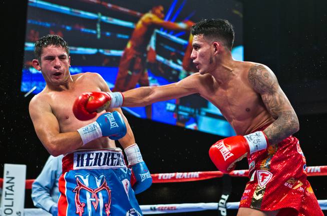 Jose Benavidez Jr. drives Mauricio Herrera back with a glancing right hand during their interim WBA super lightweight title fight at the Cosmopolitan on Saturday, Dec. 13, 2014.