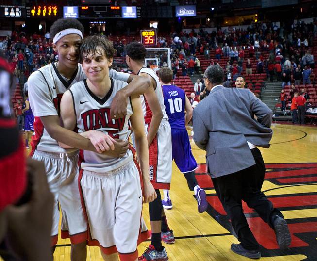 UNLV guards Patrick McCaw and Cody Doolin celebrate their 75-73 overtime win over Portland on Wednesday, Dec. 17, 2014, at the Thomas & Mack Center.