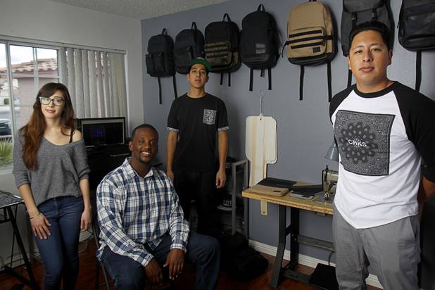 The Revive Brand Co. team poses in their home office Thursday, Dec. 18, 2014. From left:  Amanda Appling, creative director, Medin Gebrezgier, chief marketing officer, Cesar Santos, research and development/production manager, and Jonathan Santos, CEO.