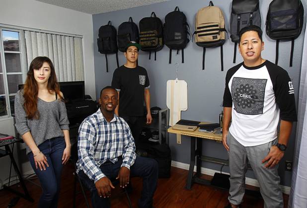 The Revive Brand Co. team poses in their home office Thursday, Dec. 18, 2014. From left:  Amanda Appling, creative director, Medin Gebrezgier, chief marketing officer, Cesar Santos, research and development/production manager, and Jonathan Santos, CEO.