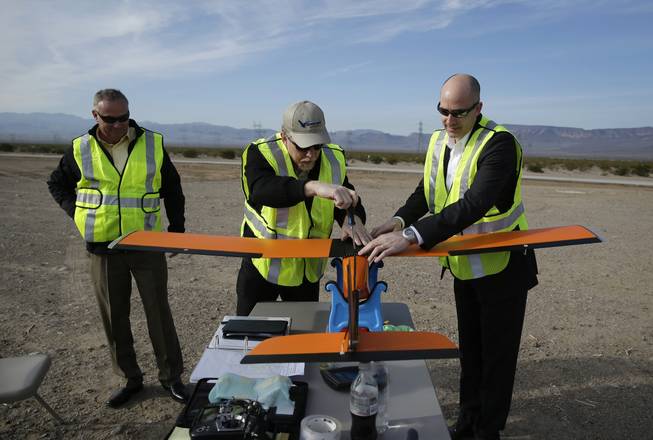 Joe Burns, Scott Carrigan and Dan Johnson of Sensurion Aerospace prepare the Sensurion Aerospace Magpie commercial drone for a flight Friday, Dec. 19, 2014, near Boulder City.