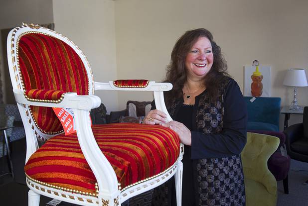 Michele Morgan-Devore, executive director of the nonprofit Dinosaurs & Roses thrift shop, 4310 E. Tropicana Ave., poses with new furniture donated by the World Market Center at the store Tuesday, Dec. 23, 2014.