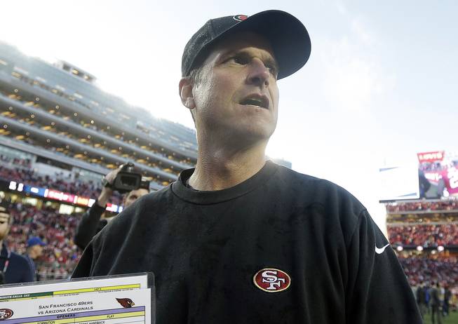 San Francisco 49ers head coach Jim Harbaugh walks off the field after an NFL game against the Arizona Cardinals in Santa Clara, Calif., on Sunday, Dec. 28, 2014. The 49ers won 20-17.