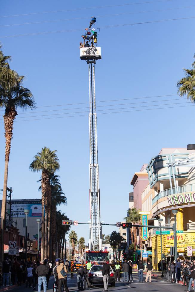 Las Vegas firefighters rescued a man who was stuck in midair on the SlotZilla ride at Fremont Street Experience on Friday, Jan. 2, 2015.