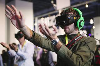 A consumer plays a video game using an OSVR (Open Source Virtual Reality) headset on display at CES 2015 in the Las Vegas Convention Center on Wednesday, January 7, 2015.