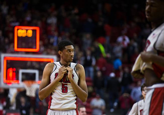 UNLV forward Christian Wood (5) looks to the UNR players celebrating their late-game win 64-62 at the Thomas & Mack Center on Wednesday, January 7, 2015. L.E. Baskow.