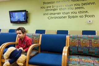 Three-year-old Elann Saula sits in the reception area awaiting connection treatment for lymphangiectasia, a rare disease centered in his intestines, at Children's Specialty Center of Nevada in Las Vegas Thursday, January 8, 2015.  Elann is the son of 