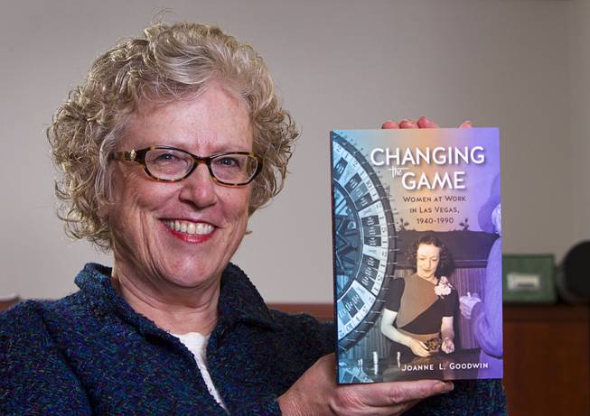 Joanne Goodwin, a UNLV history professor and director of the Women's Research Institute, poses with her book "Changing the Game: Women at Work in Las Vegas 1940-1990" at UNLV Monday, Jan. 12, 2015. 