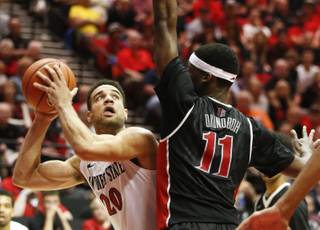 San Diego State forward J.J. O'Brien gets ready to shoot over UNLV forward Goodluck Okonoboh during the second half of an NCAA college basketball game won 53-47 by San Diego State Saturday, Jan. 17, 2015, in San Diego. (AP Photo/Lenny Ignelzi)