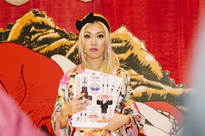 A model hands out brochures at the R18 booth during the 2015 AVN/Adult Entertainment Expo on Friday, Jan. 23, 2015, at the Hard Rock Hotel.