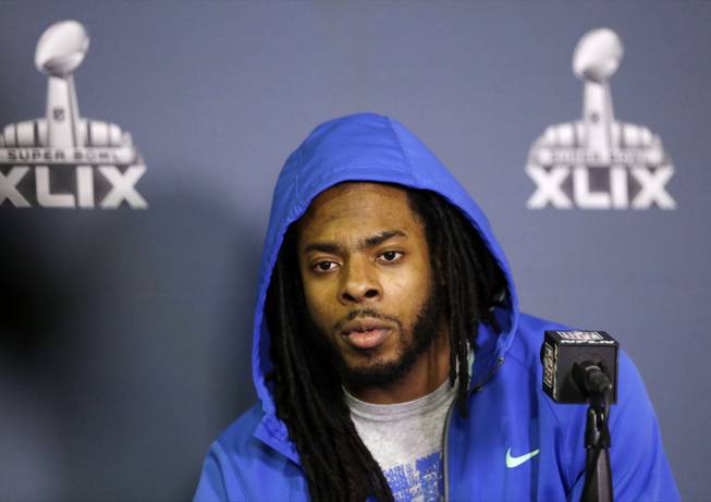 Seattle Seahawks' Richard Sherman answers a question at a news conference for NFL Super Bowl XLIX on Sunday, Jan. 25, 2015, in Phoenix. The Seahawks play the New England Patriots in Super Bowl XLIX on Sunday, Feb. 1, 2015.