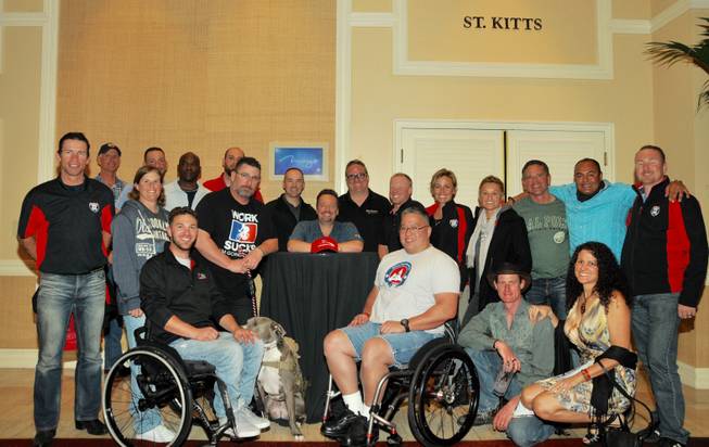 Terry Fator, behind table, and Ride 2 Recovery Wounded Warriors on Tuesday, Jan. 27, 2015, at the Mirage.