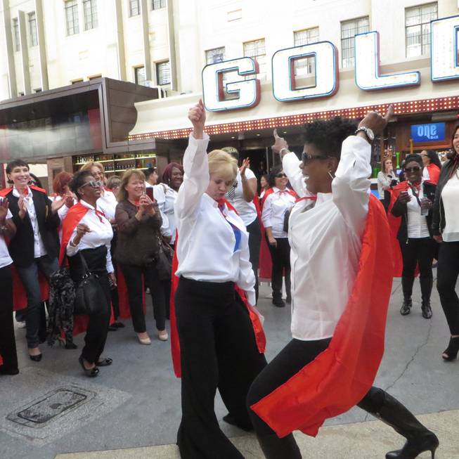 CCSD administrators dance on Fremont Street Wednesday, Jan. 28, 2015, to kick off CCSD's newest marketing campaign, which encourages potential teachers to "be a hero" by signing on to work in the district. 