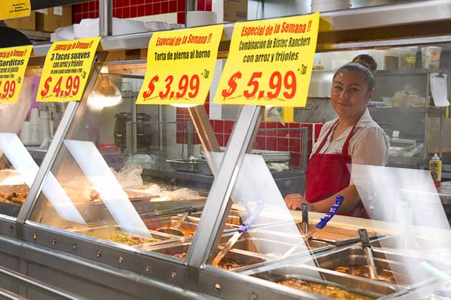 Los Compadres #4, a family-owned market, on East Tropicana Avenue offers prepared foods Wednesday, Feb. 4, 2015. A Cardenas supermarket opened across the street from the market in in Nov. 2014.