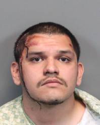 In this Tuesday, Feb. 10, 2015, provided by the Washoe County Sheriff's Office, Cesar Romero, 20, poses for a mug shot in Reno, Nev., after he was booked on several charges accusing him of shooting a man in a road-rage incident on a suburban street in neighboring Sparks. 