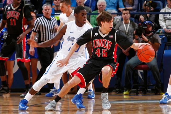 UNLV guard Cody Doolin dribbles the ball against Air Force guard Trevor Lyons on Saturday, Feb. 14, 2015, at Air Force Academy, Colo. Air Force won 76-75. 