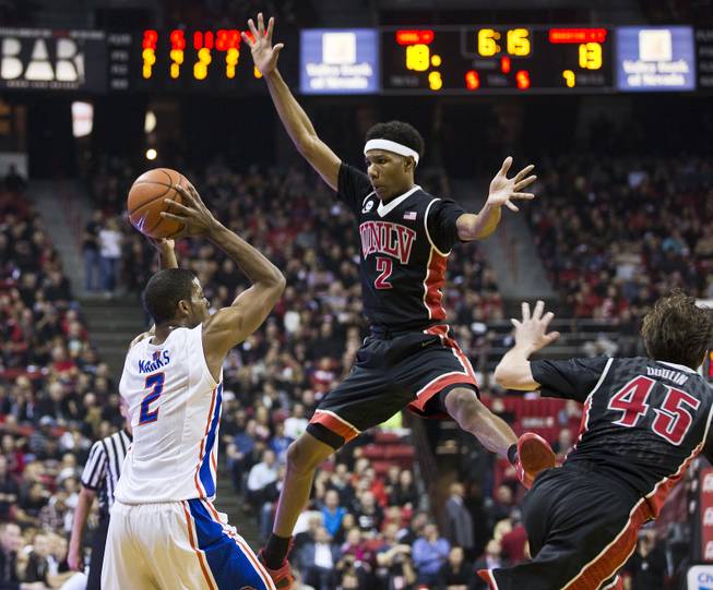 The UNLV basketball team guard Patrick McCaw (2) gets up high to defend against Boise State guard Derrick Marks (2) during their game Wednesday, February, 18. 2015.