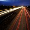 In this photo made with a 25-second exposure on Thursday, Feb. 12, 2015, vehicles travel along Interstate 70 in Wright City, Mo. Built in the 1950s and '60s with an expected life of 20 years, a 200-mile span of the four-lane interstate between suburban St. Louis and Kansas City is crumbling beneath its surface as it carries more than 30,000 vehicles a day on many of its rural stretches. 
