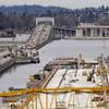 In this Dec. 16, 2014, photo, work continues on the new Highway 520 floating bridge across Lake Washington as traffic moves along the adjacent, existing four-lane bridge between Medina, Wash., and Seattle. Washington has imposed fees on owners of electric vehicles, and Gov. Jay Inslee recently proposed a carbon-emissions tax on the state’s largest polluters that would help finance transportation projects. He describes it as “transportation pollution paying for transportation solutions.”