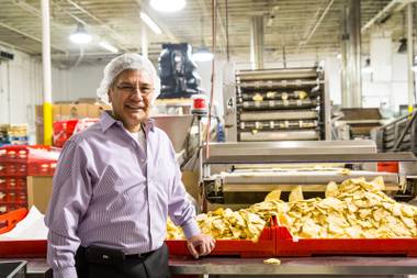 Owner Gus Gutierrez stands amidst the production lines of chips and tortillas begin made in his family-owned tortilla factory Tortillas Incorporated in North Las Vegas January 22, 2015.