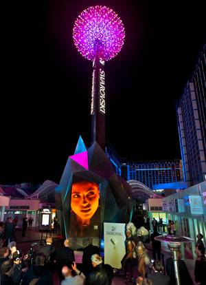 Attendees enjoy an opening show at the Swarovski Pavilion and Starburst at Grand Bazaar Shops now open to the public with the Swarovski Crystal Starburst that towers above Grand Bazaar Shops and the Las Vegas Strip illuminated at the Midnight Celebration for the first time on Thursday, February, 26, 2015.