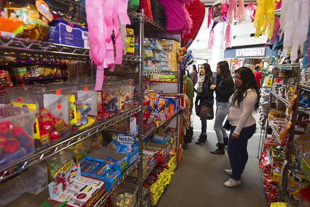 Customers look over candy in Christy's Candy Shop at the Boulevard Mall Sunday, March 1, 2015.